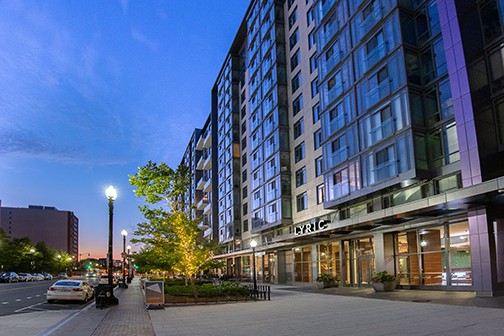 Street entrance to Lyric apartment building at dusk