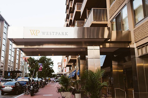 Covered entryway to WestPark Apartments with storefronts