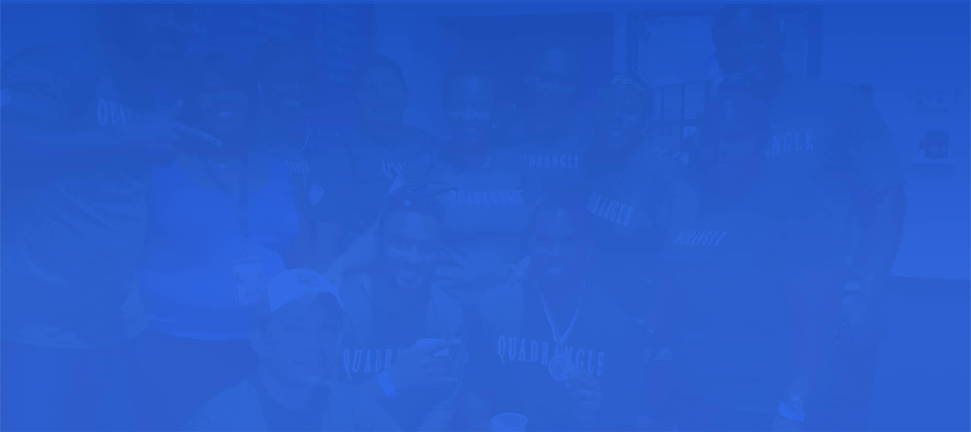 People pose for a photo against blue background