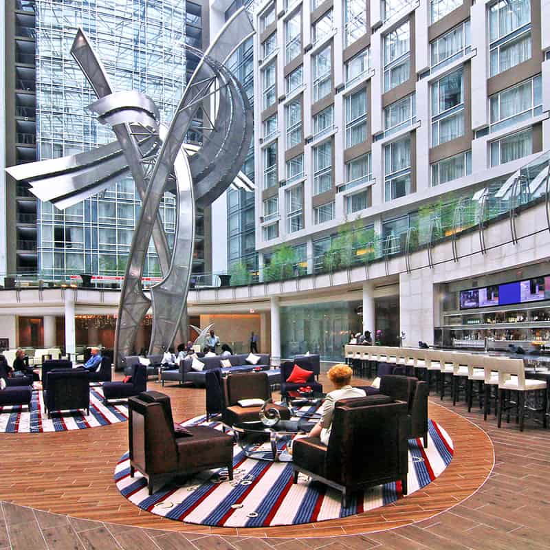 Seating area in multi-story lobby with large sculpture in the center