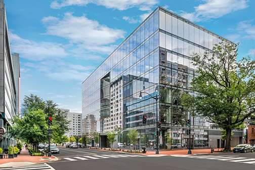 Glass commercial building on city street corner